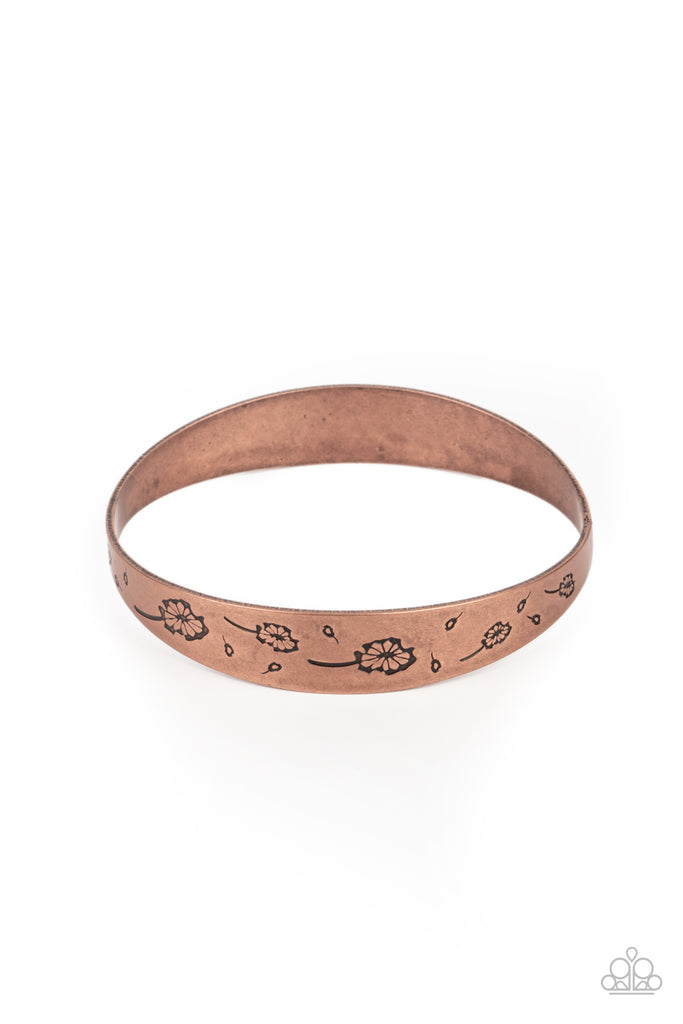 Flowery dandelion-like patterns are stamped across the front of an uneven copper bangle, creating a stackable seasonal display around the wrist.  Sold as one individual bracelet.  