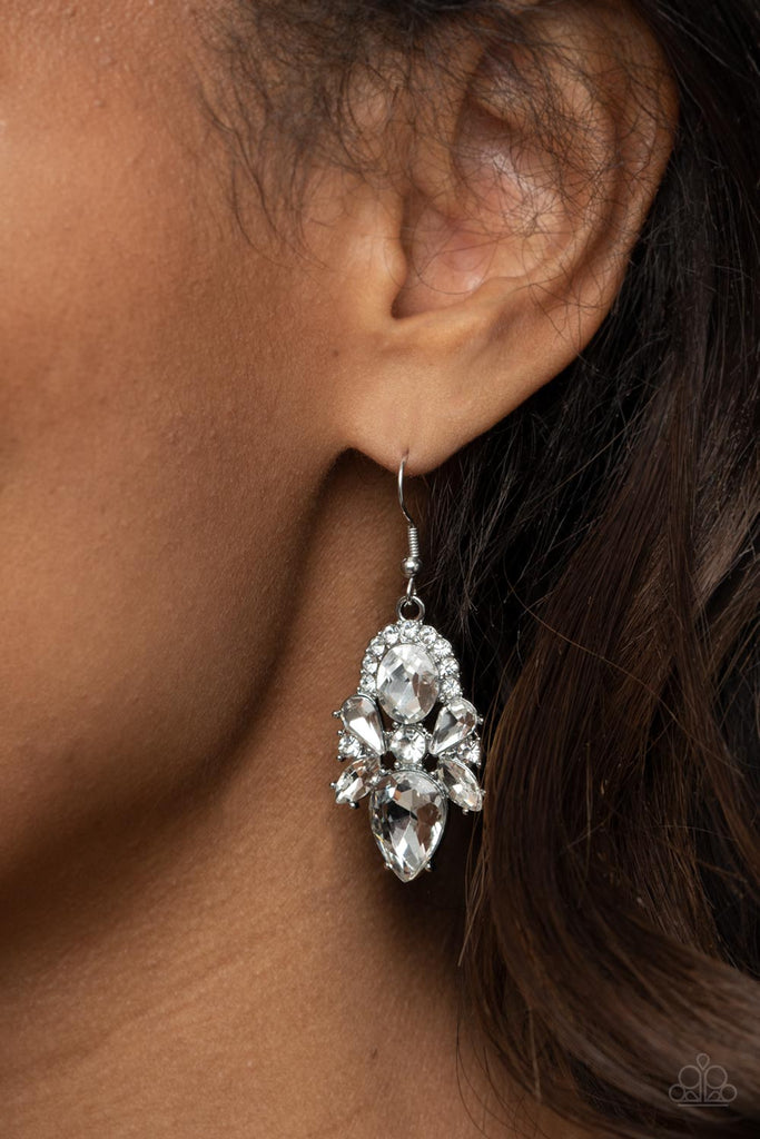 Featuring regal marquise, teardrop, and oval cuts, a sparkly collection of glassy white rhinestones adorn a glittery backdrop of glassy white rhinestones, creating a dramatically dazzling centerpiece. Earring attaches to a standard fishhook fitting.  Sold as one pair of earrings.