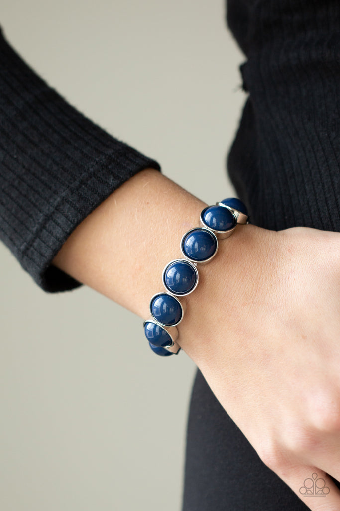 Featuring depthless blue beaded centers, bubbly silver frames are threaded along stretchy bands around the wrist for a powerful pop of color.  Sold as one individual bracelet.