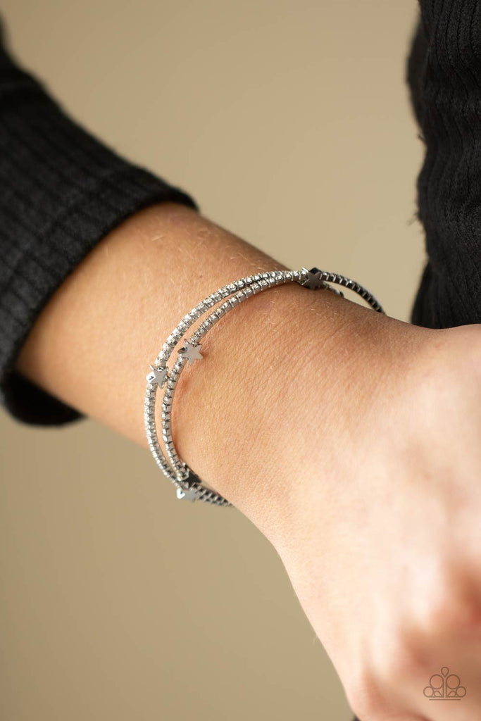 Dotted with dainty silver star charms, a bendable row of glittery white rhinestones spirals around the wrist, creating a sparkly infinity wrap bracelet.  Sold as one individual bracelet.  