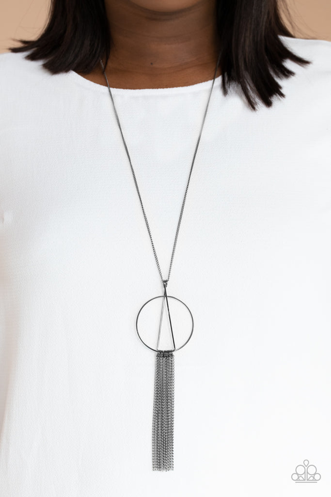 Two gunmetal rods delicately overlap at the top of a gunmetal hoop, creating an abstract pendant at the bottom of a lengthened gunmetal chain. Shimmery gunmetal chains stream from the bottom of the frame, creating a sleek tassel. Features an adjustable clasp closure.  Sold as one individual necklace. Includes one pair of matching earrings.