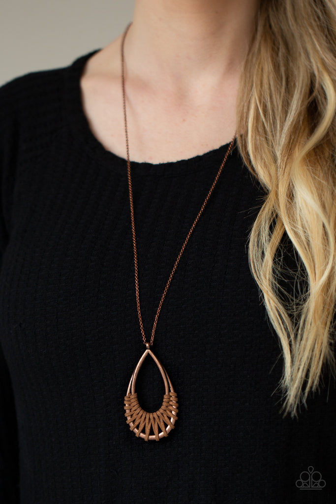 Brown suede cording loops and weaves around the bottoms of a double stacked copper teardrop frame, creating an earthy pendant at the bottom of a dainty lengthened copper chain. Features an adjustable clasp closure.  Sold as one individual necklace. Includes one pair of matching earrings.