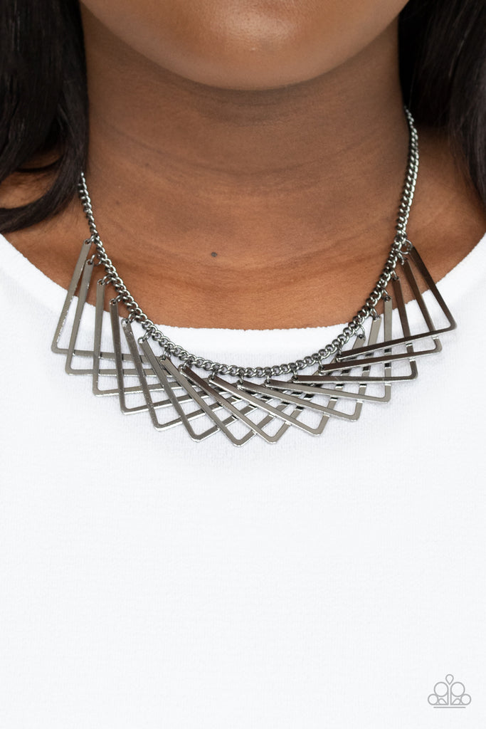 A shiny collection of gunmetal V-shape frames delicately overlap below the collar, creating an edgy optical illusion. Features an adjustable clasp closure.  Sold as one individual necklace. Includes one pair of matching earrings.  New Kit