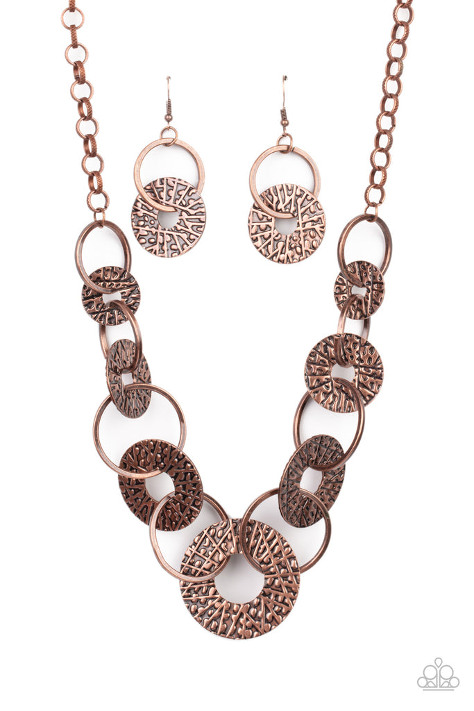 Gradually increasing in size near the center, a collection of antiqued copper rings and abstract hammered discs interlock below the collar for an intense industrial look. Features an adjustable clasp closure.  Sold as one individual necklace. Includes one pair of matching earrings.
