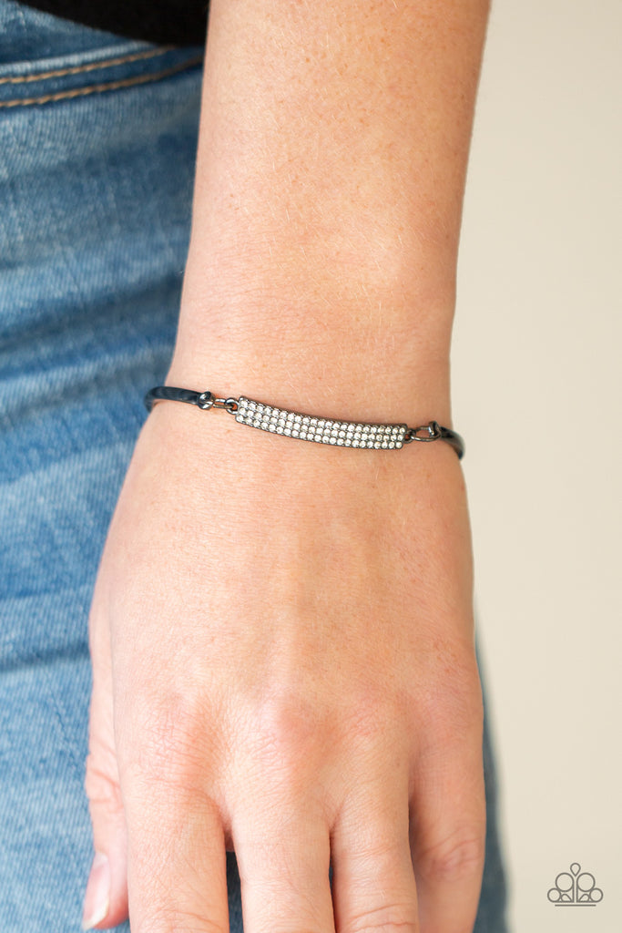 Two arcing gunmetal bands link with a gunmetal frame encrusted in row after row of glassy white rhinestones, creating a sparkly centerpiece around the wrist. Features an adjustable clasp closure.  Sold as one individual bracelet.  New Kit