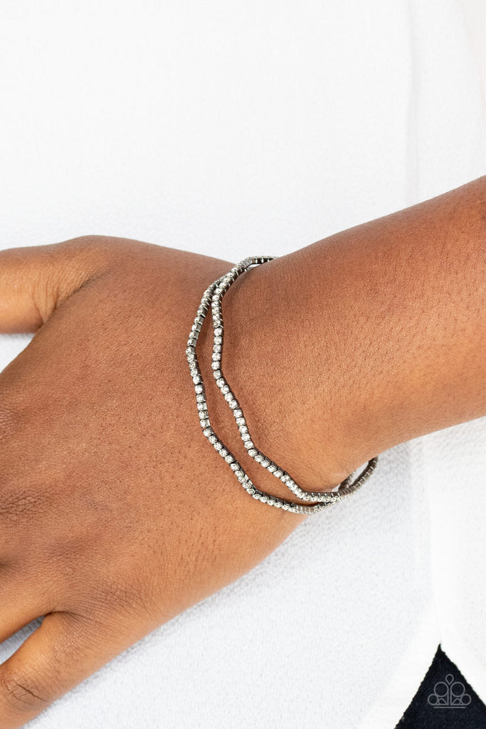 Wavy rows of glittery white rhinestones delicately connect into a dainty gunmetal cuff around the wrist, creating a timeless centerpiece.  Sold as one individual bracelet.