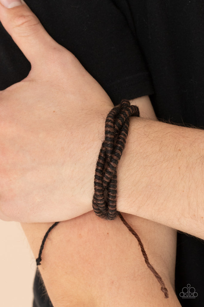 Featuring a distressed finish, black and brown spun cording weaves across the wrist for a rugged earthy look. Features an adjustable sliding knot closure.  Sold as one individual bracelet.