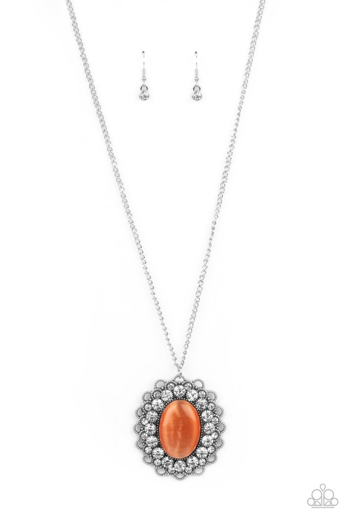 Bordered in bubbly white rhinestone encrusted petals, the center of a studded silver floral frame is dotted with an oversized orange cat's eye stone, creating a whimsical medallion at the bottom of a lengthened silver chain. Features an adjustable clasp closure.  Sold as one individual necklace. Includes one pair of matching earrings.