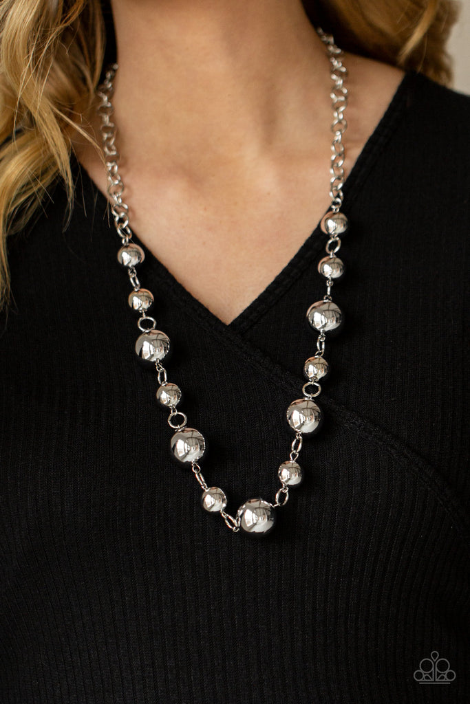 An oversized collection of intense silver beads boldly link below the collar, creating a dramatic industrial display. Features an adjustable clasp closure.  Sold as one individual necklace. Includes one pair of matching earrings.