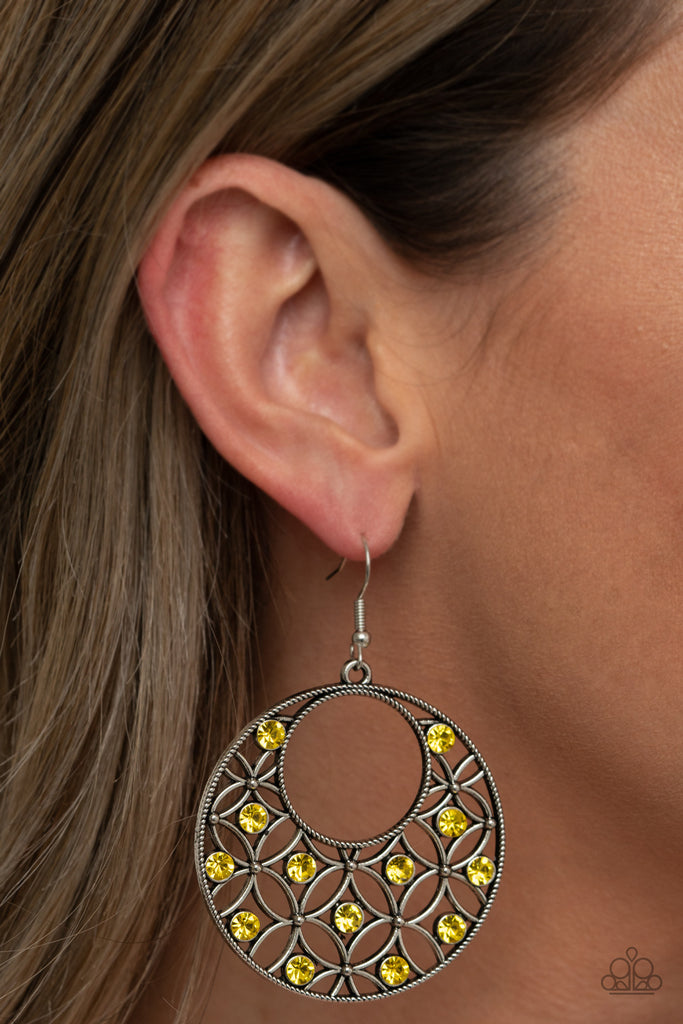 Dotted with glittery Illuminating rhinestones, an airy backdrop of antiqued flowers climb a studded silver hoop for a whimsical look. Earring attaches to a standard fishhook fitting.  Sold as one pair of earrings.