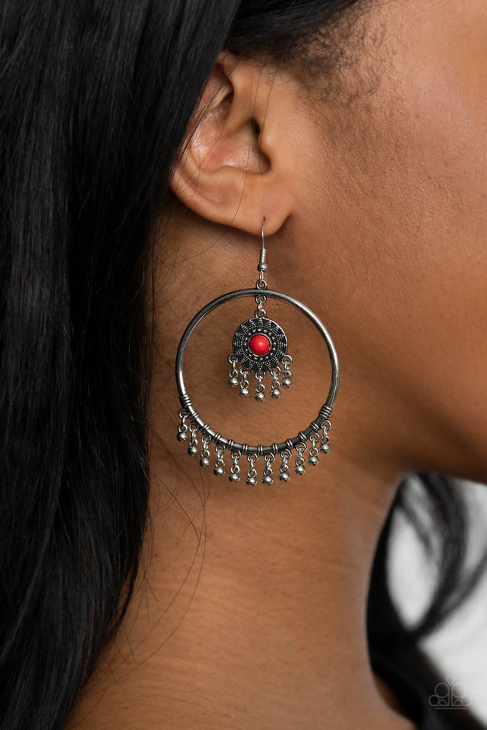 Dotted with a red stone, a dainty sunburst studded frame swings from the top of a shiny silver hoop featuring a silver beaded fringe for a trendy stone look. Earring attaches to a standard fishhook fitting.  Sold as one pair of earrings.