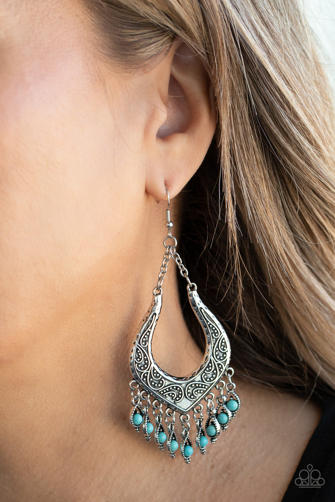 Dotted with dainty turquoise stones, decorative silver frames swing from the bottom of an ornately studded silver frame, creating a simply seasonal fringe. Earring attaches to a standard fishhook fitting.  Sold as one pair of earrings.