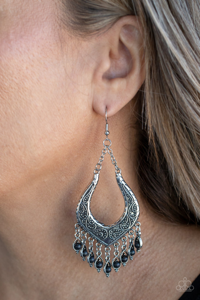 Dotted with dainty black stones, decorative silver frames swing from the bottom of an ornately studded silver frame, creating a simply seasonal fringe. Earring attaches to a standard fishhook fitting.  Sold as one pair of earrings.