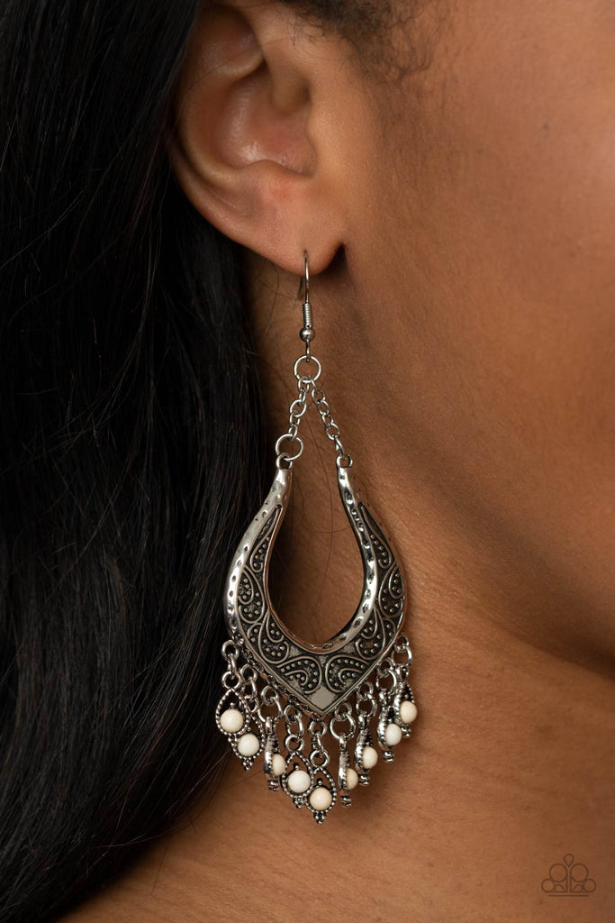 Dotted with dainty white stones, decorative silver frames swing from the bottom of an ornately studded silver frame, creating a simply seasonal fringe. Earring attaches to a standard fishhook fitting.  Sold as one pair of earrings.  