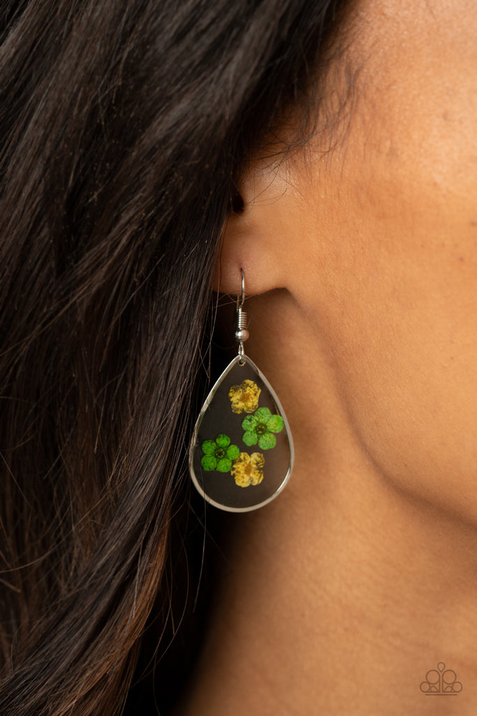 Dainty yellow and green flowers are encased in a glassy teardrop, creating a whimsical frame. Earring attaches to a standard fishhook fitting.  Sold as one pair of earrings.
