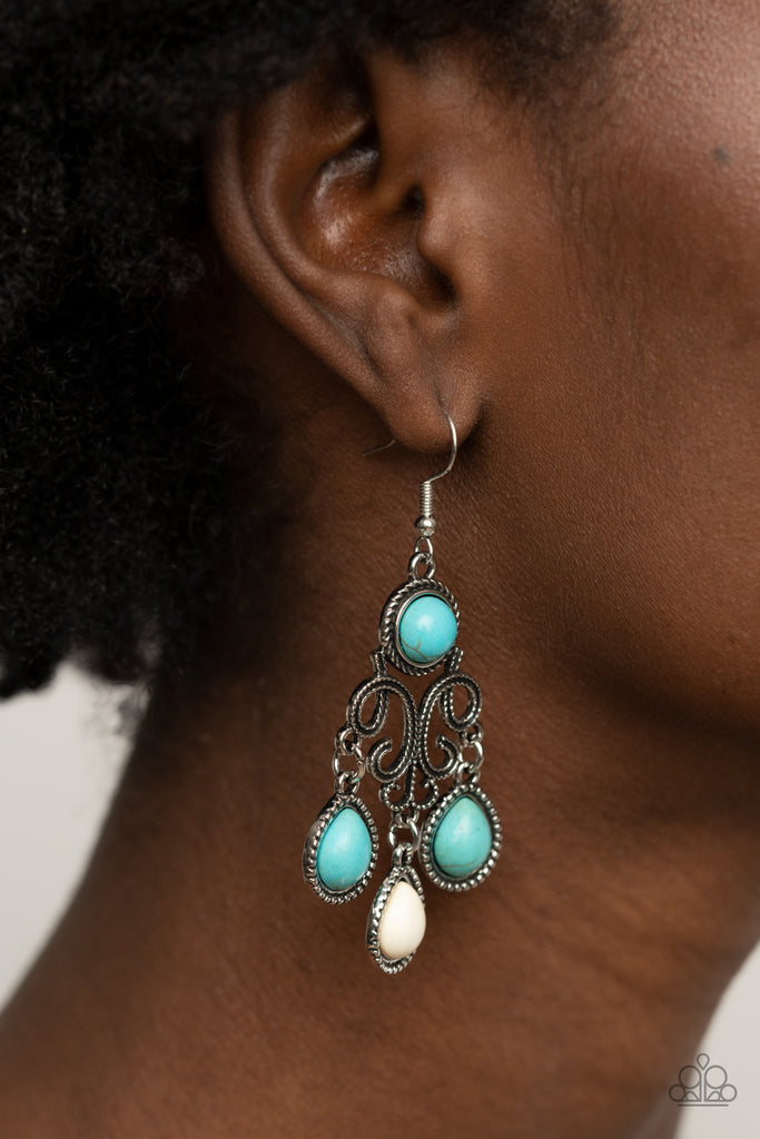 Refreshing turquoise and white stone dotted frames swing from the bottom of a filigree filled chandelier dotted with a matching turquoise stone, creating an earthy fringe. Earring attaches to a standard fishhook fitting.  Sold as one pair of earrings.