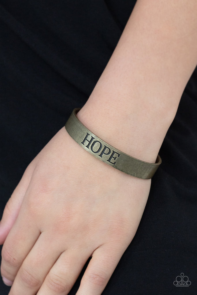 The center of a rustic brass cuff is stamped in the word, "Hope," for an inspirational look.  Sold as one individual bracelet.