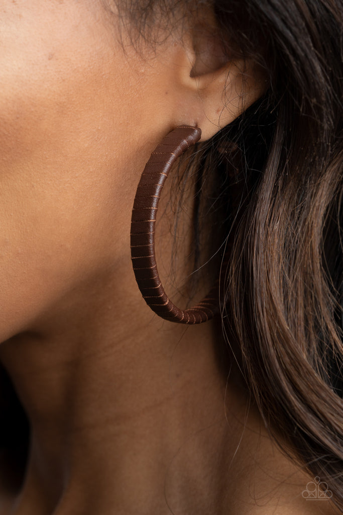 A rustic brown leather lace wraps around a thick silver hoop, creating an edgy display. Earring attaches to a standard post fitting. Hoop measures approximately 2 1/2" in diameter.  Sold as one pair of hoop earrings.  New Kit