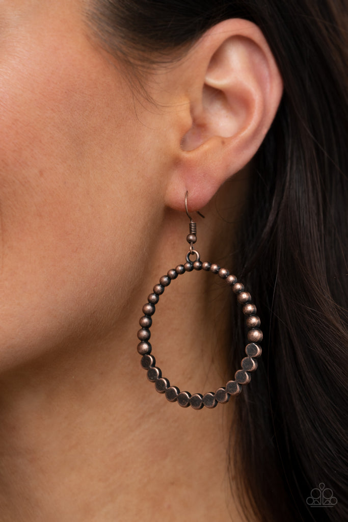 Antiqued copper studs join with flattened copper studs, creating a rustic hoop. Earring attaches to a standard fishhook fitting.  Sold as one pair of earrings.
