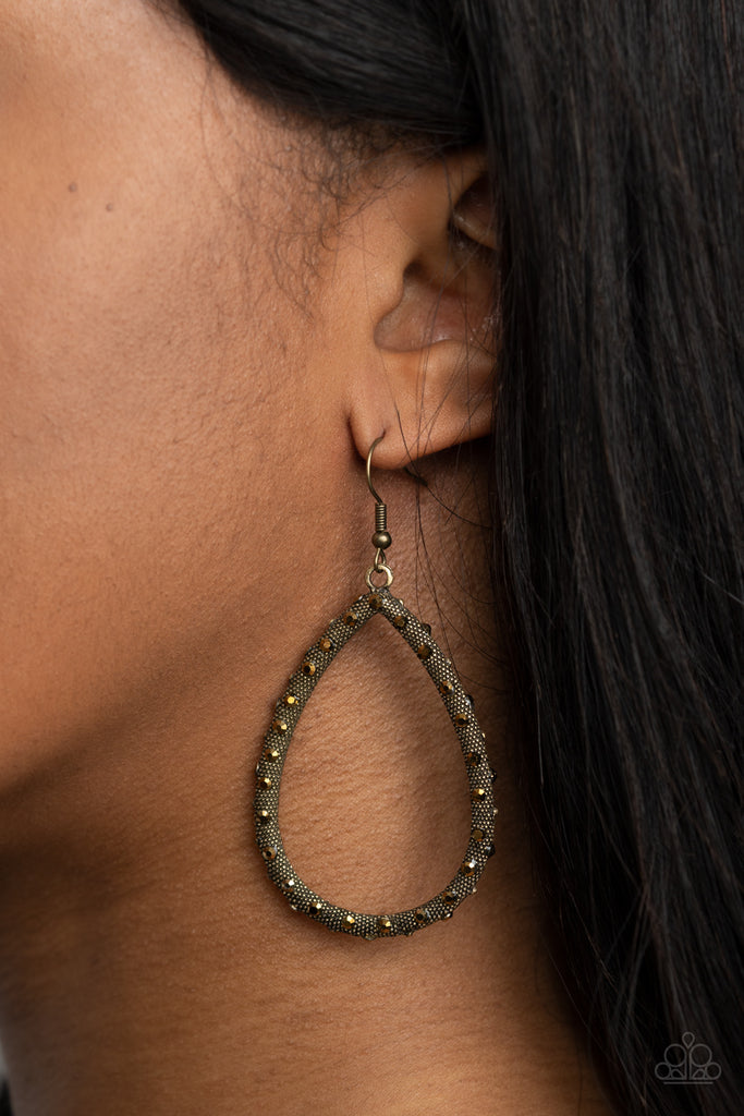 As if rolled in glitter, a studded brass teardrop frame is dotted in faceted aurum rhinestones for a gritty, glamorous look. Earring attaches to a standard fishhook fitting.  Sold as one pair of earrings.  