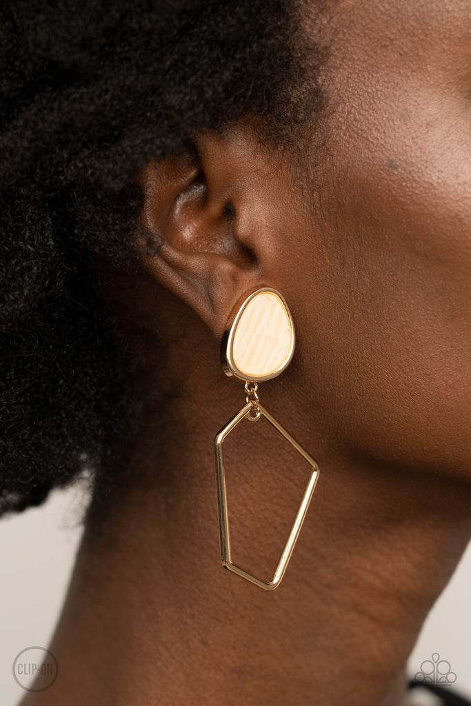 Encased in a classic gold fitting, an abstract faux stone fitting gives way to an airy geometric gold frame for a refined asymmetrical look. Earring attaches to a standard clip-on fitting.  Sold as one pair of clip-on earrings.