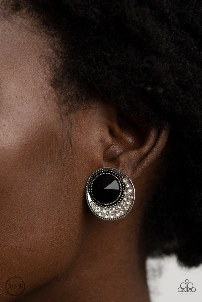 Dotted with an oversized black gem, the flared bottom of a studded silver frame is encrusted in row after row of glassy white rhinestones for a refined flair. Earring attaches to a standard clip-on fitting.  Sold as one pair of clip-on earrings.