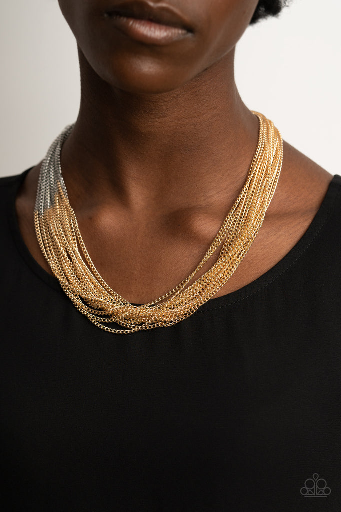 Sections of glistening gold chains collide with shimmery silver chains below the collar, linking into dramatic layers for an edgy effect. Features an adjustable clasp closure.  Sold as one individual necklace. Includes one pair of matching earrings.