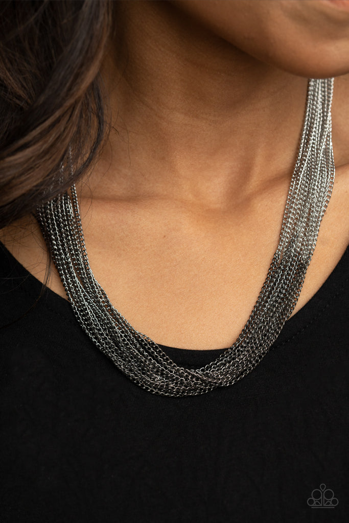Sections of glistening gunmetal chains collide with shimmery silver chains below the collar, linking into dramatic layers for an edgy effect. Features an adjustable clasp closure.  Sold as one individual necklace. Includes one pair of matching earrings.