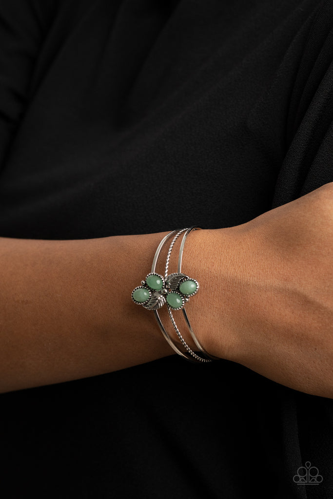 Infused with leafy silver frames, a cluster of jade stone frames collect atop a layered silver cuff, creating an earthy centerpiece.  Sold as one individual bracelet.