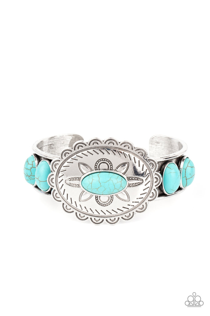 Dotted with a refreshing turquoise stone, a floral stamped scalloped silver frame sits atop a turquoise studded silver cuff, creating a southwestern inspired buckle atop the wrist.  Sold as one individual bracelet.