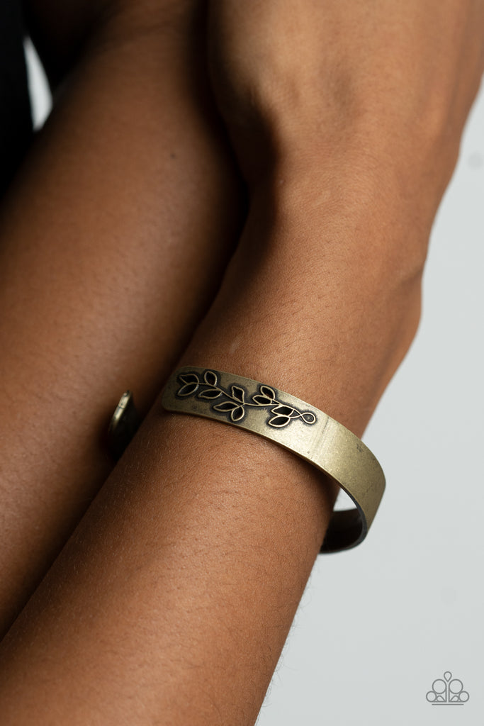 The ends of a dainty brass cuff are cut out and embossed in rustic leafy filigree, creating a simple seasonal centerpiece around the wrist.  Sold as one individual bracelet.