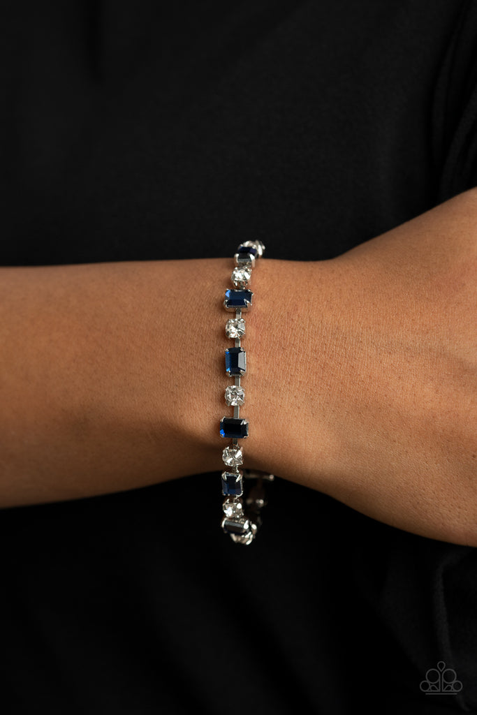 Featuring pronged silver fittings, emerald cut blue rhinestones alter in position as they alternate with classic white rhinestones around the wrist for a timeless look. Features an adjustable clasp closure.  Sold as one individual bracelet.