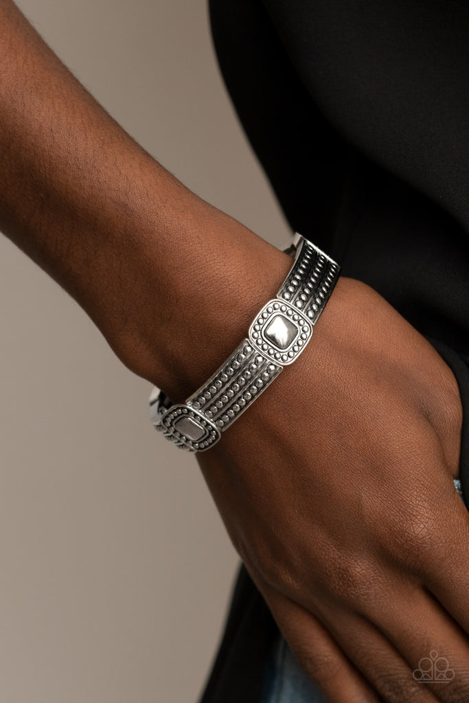 Featuring silver studded patterns, square and rectangular frames are threaded along stretchy bands around the wrist for a rustic flair.  Sold as one individual bracelet.  