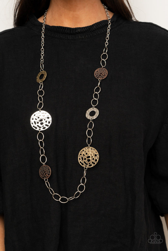 Featuring rustic finishes, hammered silver hoops and holey brass and copper discs link with sections of oversized silver links across the chest for an artisan inspired look. Features an adjustable clasp closure.  Sold as one individual necklace. Includes one pair of matching earrings.