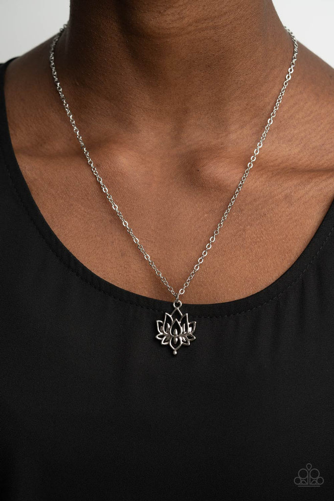 A shiny silver lotus blooms along a dainty silver chain, creating a whimsical pendant below the collar. Features an adjustable clasp closure.  Sold as one individual necklace. Includes one pair of matching earrin