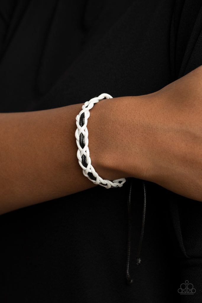 White cording weaves around a pair of black cording, creating an earthy braid around the wrist. Features an adjustable sliding knot closure.  Sold as one individual bracelet.