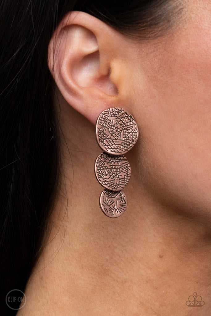 Scratched in a tactile pattern, warped copper discs decrease in size as they overlap into a rustic lure for an artisan inspired look. Earring attaches to a standard clip-on fitting.  Sold as one pair of clip-on earrings.  New Kit Clip On Earring