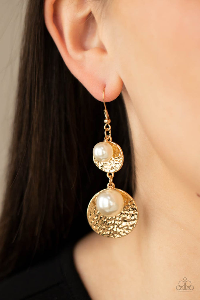 Oversized white pearls and hammered gold discs delicately link into a bubbly lure for a refined flair. Earring attaches to a standard fishhook fitting.  Sold as one pair of earrings.  