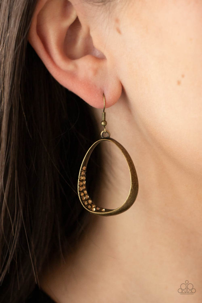 Rows of golden topaz rhinestones delicately peek out from the inside corner of an asymmetrical brass teardrop frame, creating an unexpectedly sparkly centerpiece. Earring attaches to a standard fishhook fitting.  Sold as one pair of earrings.