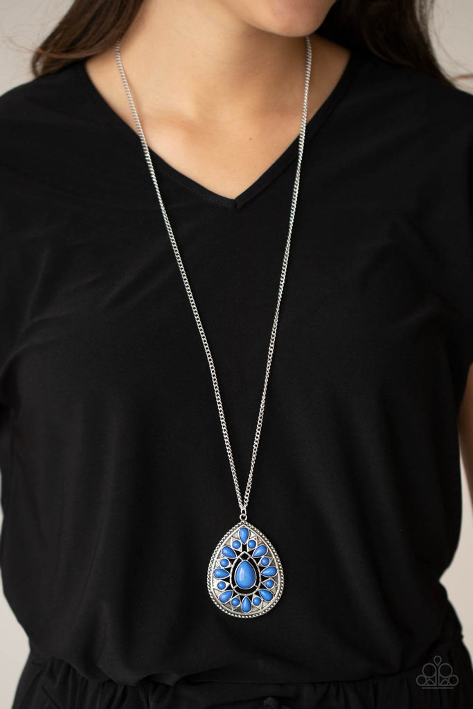 A dainty collection of round and teardrop French Blue beads flair out from an oversized teardrop bead across the front of an ornate frame. Embossed and cutout in geometric patterns, the tribal inspired pendant swings from the bottom of a lengthened silver chain for a dramatic pop of color. Features an adjustable clasp closure.  Sold as one individual necklace. Includes one pair of matching earrings.  New Kit