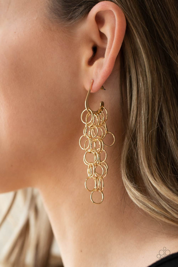 Strands of shiny gold links cascade from the bottom of a dainty hook shaped hoop, creating a rebellious fringe. Hoop measures approximately 1/2" in diameter. Earring attaches to a standard post fitting.  Sold as one pair of hoop earrings.