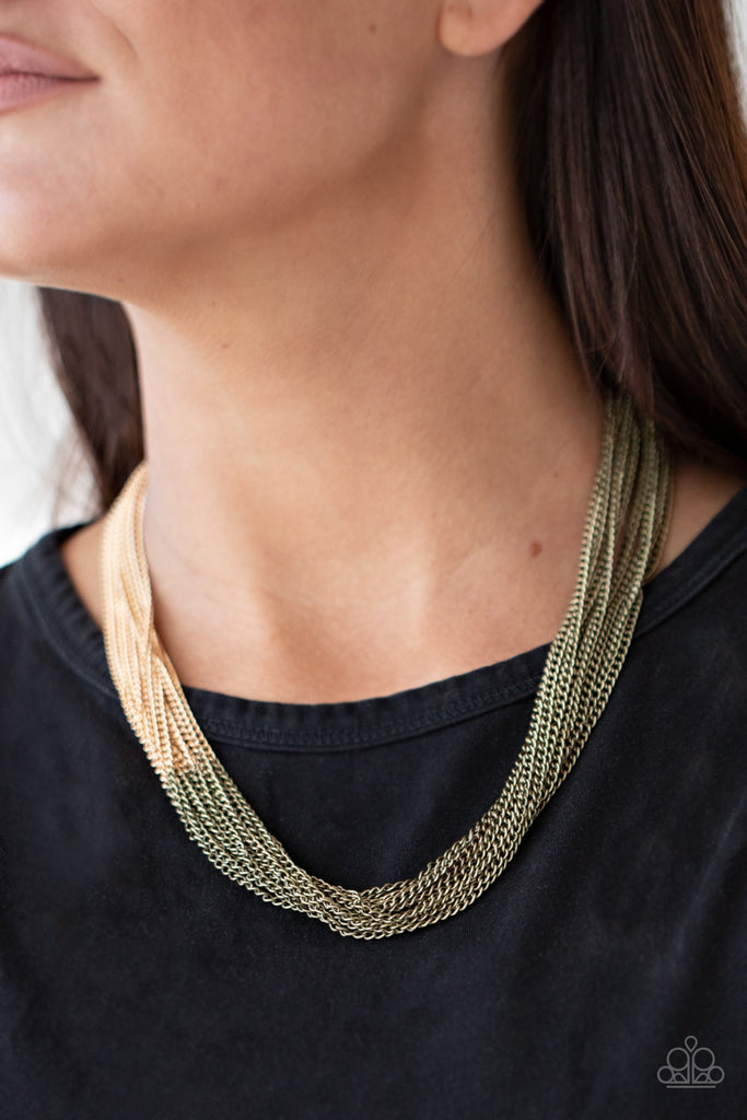 Sections of rustic brass chains collide with shimmery gold chains below the collar, linking into dramatic layers for an edgy effect. Features an adjustable clasp closure.  Sold as one individual necklace. Includes one pair of matching earrings.