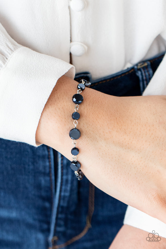 A faceted collection of metallic blue crystal-like beads delicately links around the wrist for a stellar pop of color. Features an adjustable clasp closure.  Sold as one individual bracelet.