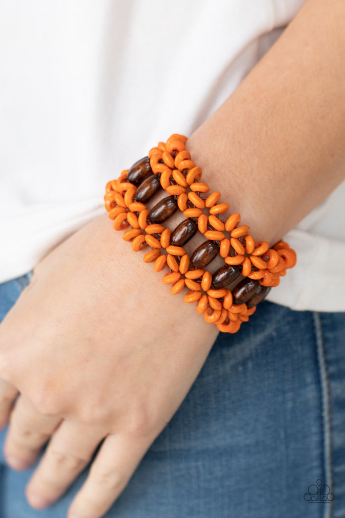 Orange wooden discs and brown wooden beads are threaded along braided stretchy bands around the wrist, creating a colorful tropical display.  Sold as one individual bracelet.  