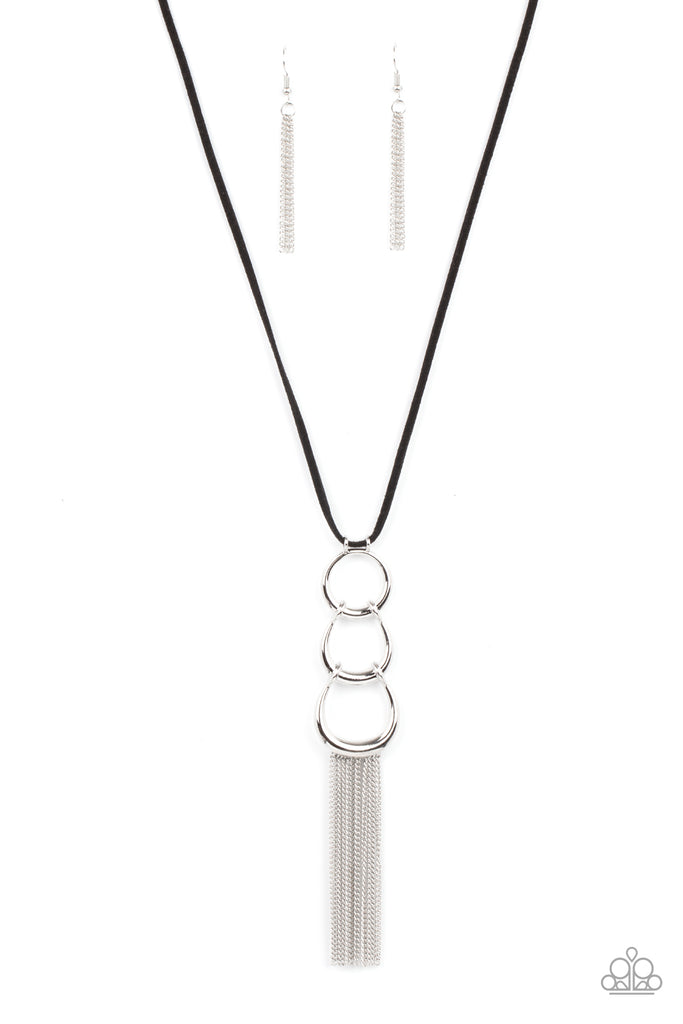 A bold silver ring gives way to two interlocking half moon silver frames at the bottom of a lengthened piece of black suede. Shimmery silver chains swing from the bottom of the display, adding flirty movement to the stationary pendant. Features an adjustable clasp closure.  Sold as one individual necklace. Includes one pair of matching earrings.