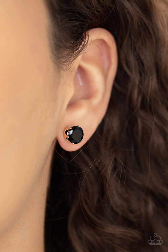 An oversized black rhinestone is nestled inside a pronged gold fitting, creating a timeless statement piece. Earring attaches to a standard post fitting.  Sold as one pair of post earrings.  