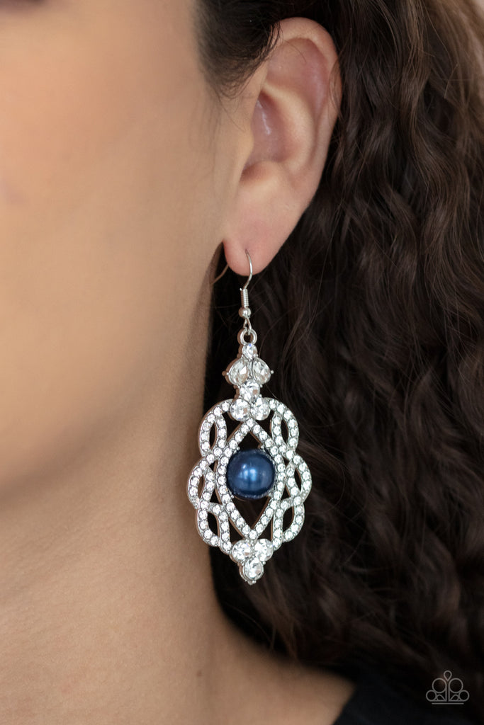 White rhinestone encrusted silver bars interloop around a pearly blue bead center, coalescing into a regal lure. Earring attaches to a standard fishhook fitting.  Sold as one pair of earrings.