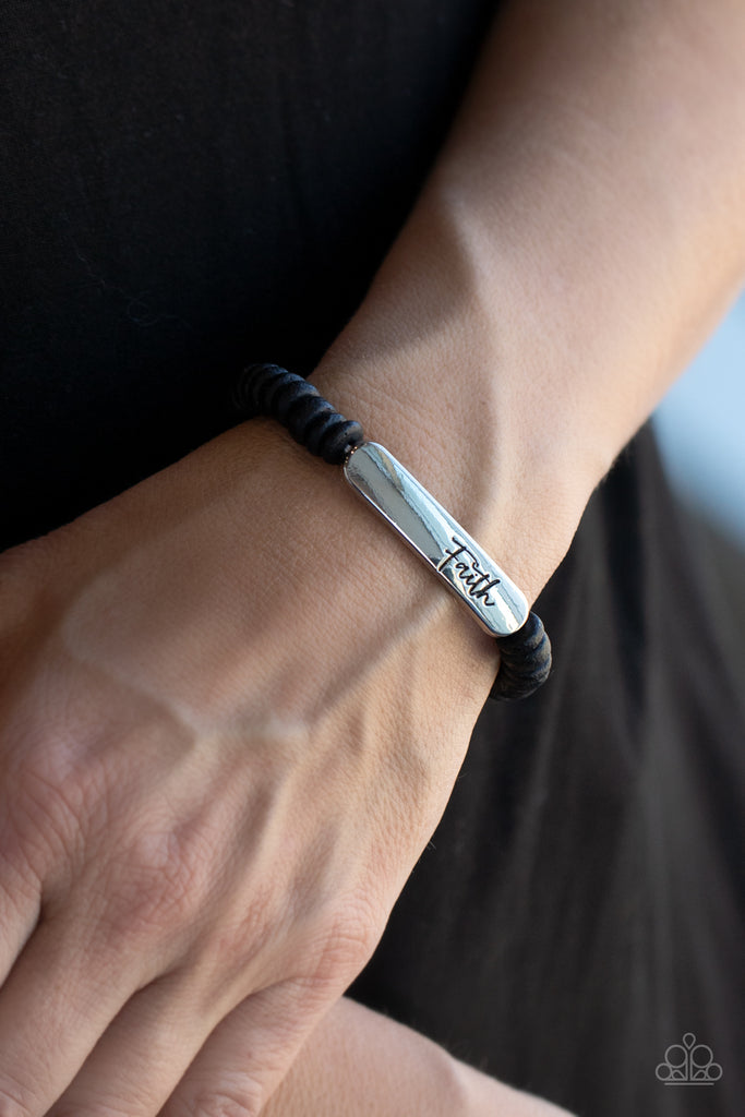 Distressed black wooden discs and a silver plate stamped in the phrase, "Faith," are threaded along a stretchy band around the wrist, creating an inspiring centerpiece.  Sold as one individual bracelet.  