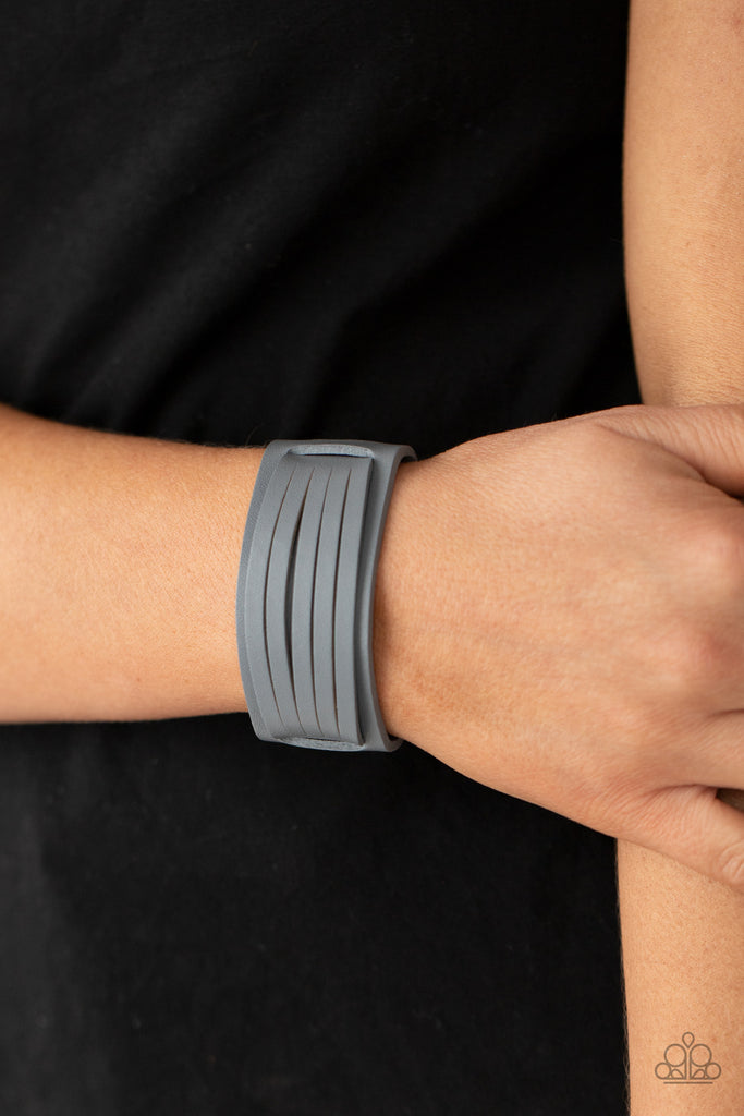 Spliced into layers, a gray leather band is threaded through the center of a larger gray leather band and studded in place for a rustic finish. Features an adjustable snap closure.  Sold as one individual bracelet.