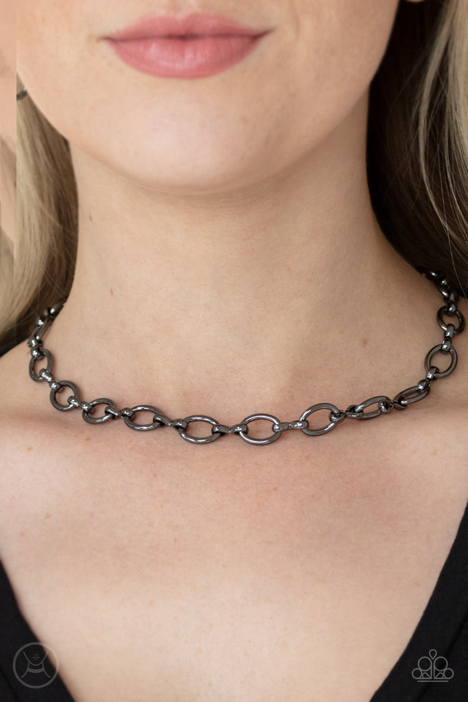 A collection of oversized gunmetal ovals and glistening gunmetal fittings interlock around the neck, creating an intense industrial look. Features an adjustable clasp closure.  Sold as one individual choker necklace. Includes one pair of matching earrings.  New Kit Choker